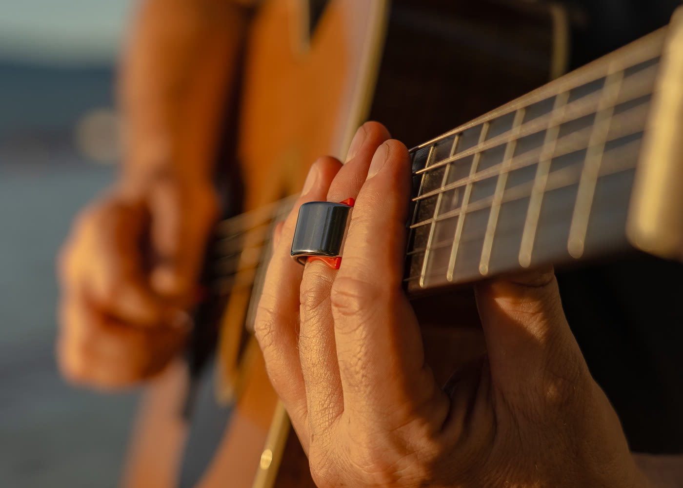 Black Mountain Slide Ring worn behind the fingertip while playing guitar